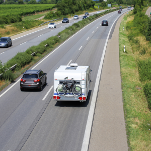 Caravan being towed by fuel efficient car down a motorway